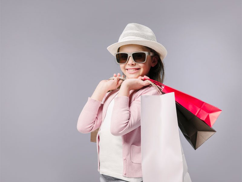 A happy shopper holding shopping bags